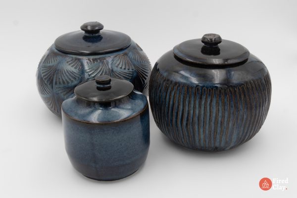 A collection of three lidded jars